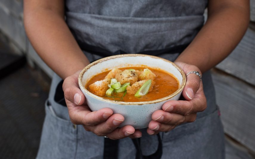 Duchy team member holding a bowl of fresh homemade soup.